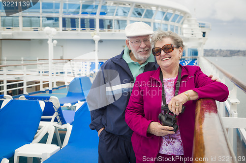 Image of Senior Couple Enjoying The Deck of a Cruise Ship