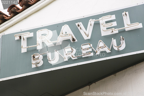 Image of Neon Travel Bureau Sign on Building