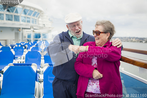 Image of Senior Couple Fist Bump on Deck of Cruise Ship