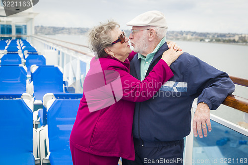 Image of Senior Couple Kissing on Deck of Cruise Ship