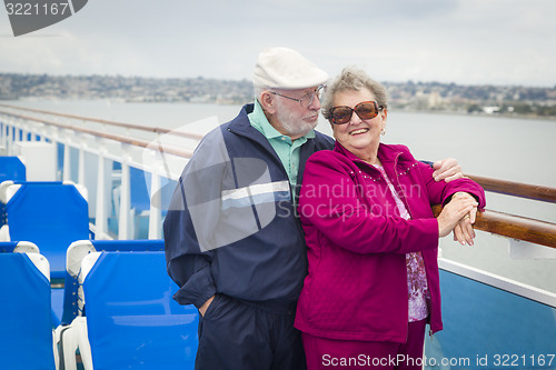 Image of Senior Couple Enjoying The Deck of a Cruise Ship