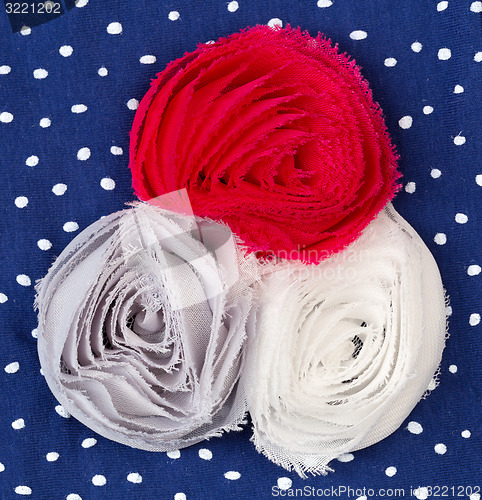 Image of Three colored fabric flower