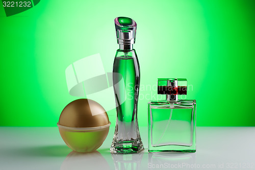 Image of Three perfume bottle on a bright green background