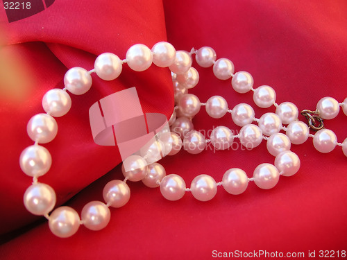 Image of pearls on red cushion