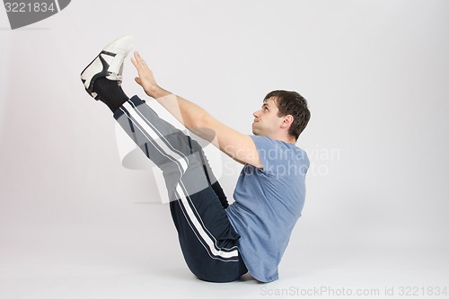 Image of Athlete stretching his arms raised to the feet