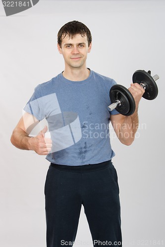 Image of athlete with a dumbbell shows class