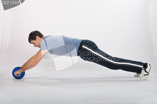 Image of Athletes perform push-ups using the wheel