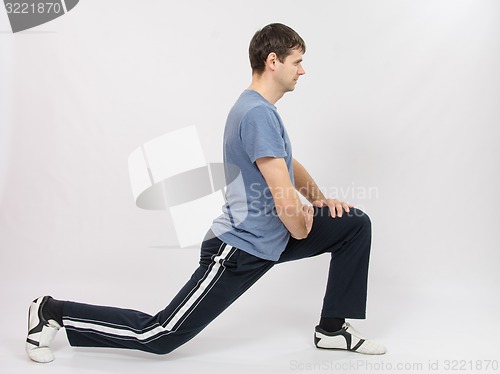 Image of The athlete performs stretching using squats