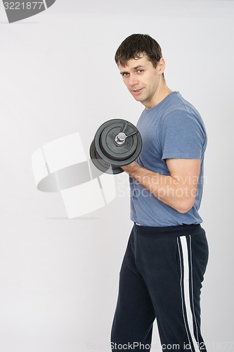 Image of Portrait of an athlete with a dumbbell in your left hand