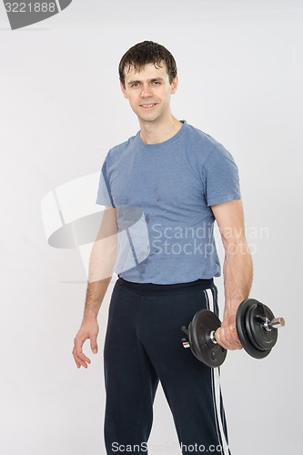 Image of Portrait of an athlete with dumbbells in the hands