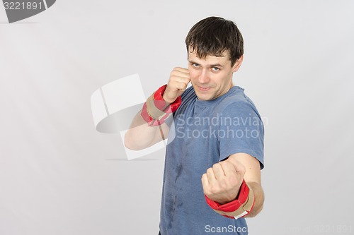 Image of Athletes perform punches with the weighting