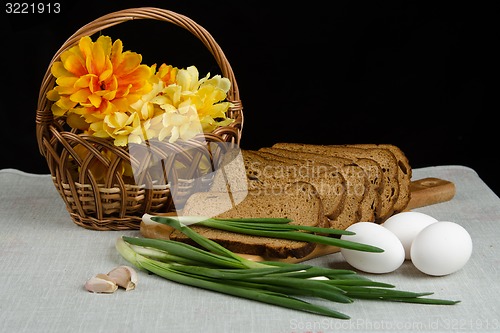 Image of Still life with rye bread, green onions and eggs