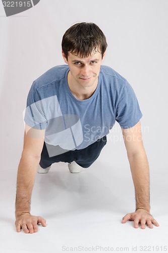 Image of Young guy pushed off the floor