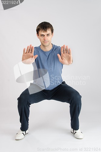 Image of Young athlete performs squats
