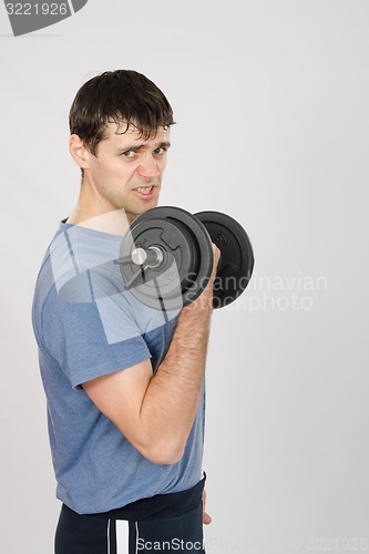 Image of Tired athlete with dumbbells