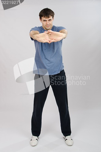 Image of young man pulls the arm muscles