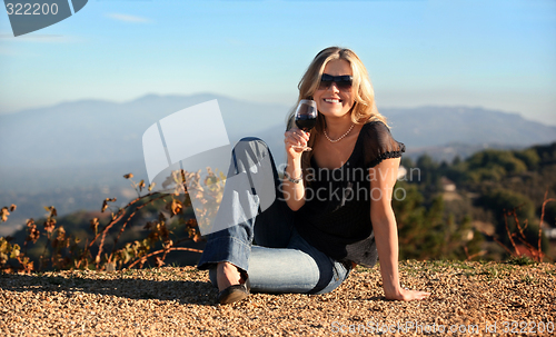 Image of Blond woman with a glass of wine