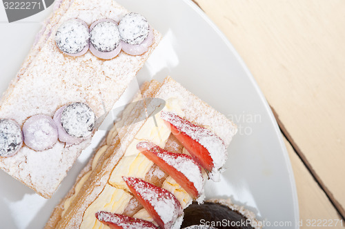 Image of selection of fresh cream cake dessert plate 