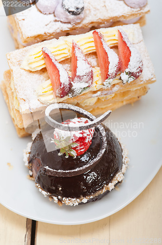 Image of selection of fresh cream cake dessert plate 