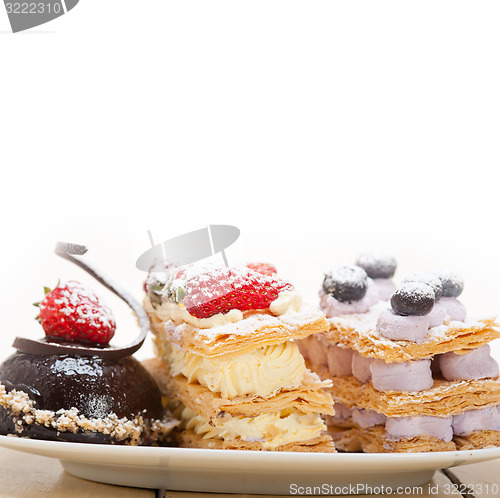 Image of selection of fresh cream cake dessert plate 