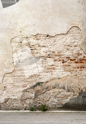 Image of abandoned grunge cracked brick stucco wall