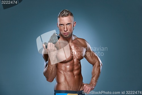 Image of Attractive male body builder onblue background