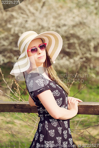 Image of Cheerful fashionable woman in stylish hat, frock and sunglasses