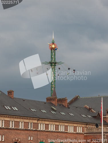 Image of The fairground fun fair in tivoli gardens. Copenhagen, Denmark, on a gray sky