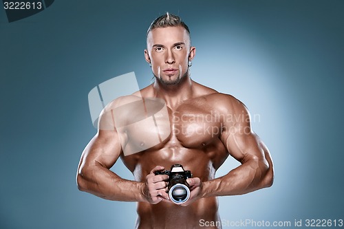 Image of Attractive male body builder onblue background