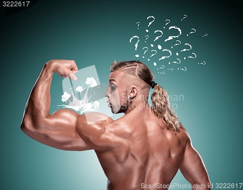 Image of Attractive male body builder on blue background