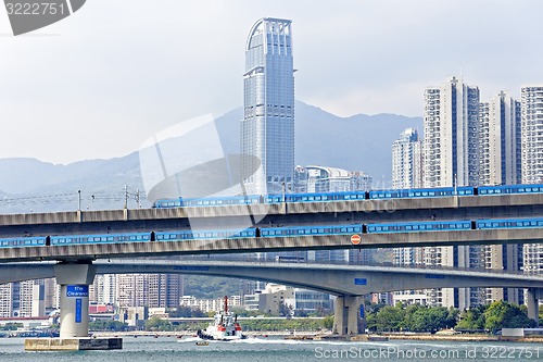 Image of high speed train on bridge in hong kong downtown city