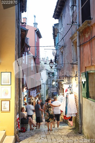 Image of Tourists walking next to souvenir shops in Rovinj