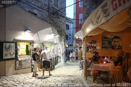 Image of Tourists walking on street in Rovinj