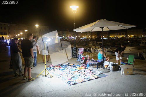 Image of Souvenir pictures on floor in Rovinj