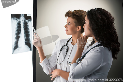 Image of Two attractive young doctors looking at x-ray results