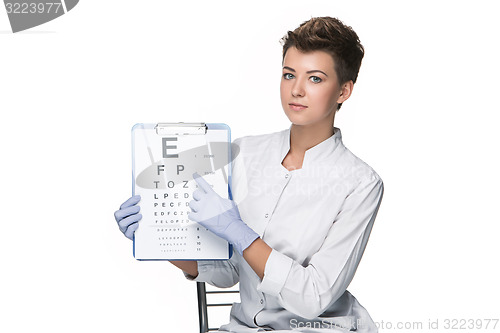 Image of young woman ophthalmologist with eye chart