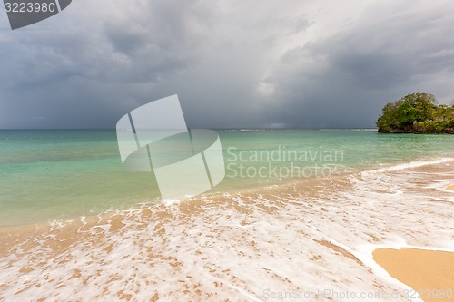 Image of Beach on tropical island. Clear blue water, sand, clouds. 