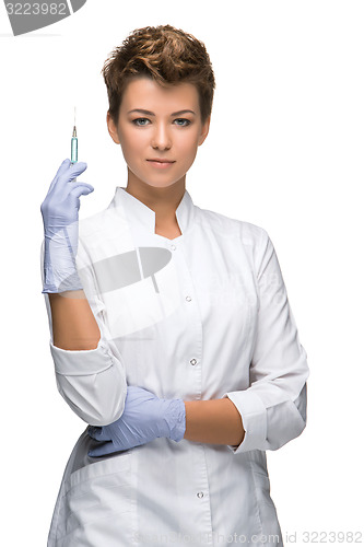 Image of Portrait of lady surgeon showing syringe 
