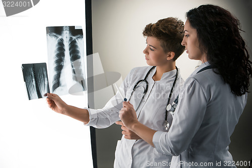 Image of Two attractive young doctors looking at x-ray results