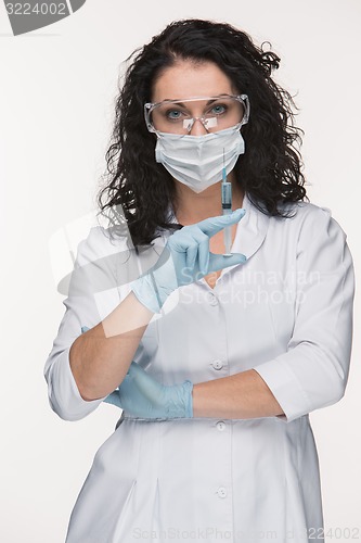Image of Portrait of lady surgeon showing syringe over white background
