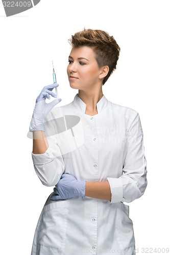 Image of Portrait of lady surgeon showing syringe 