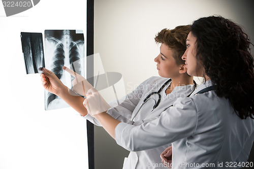 Image of Two attractive young doctors looking at x-ray results