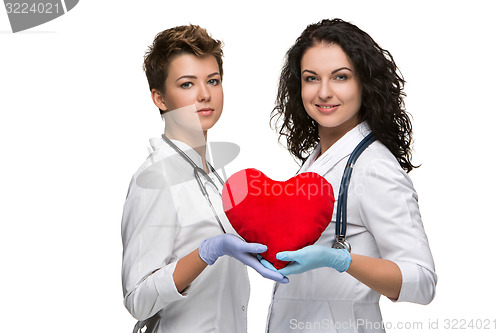 Image of Two doctors holding a red heart