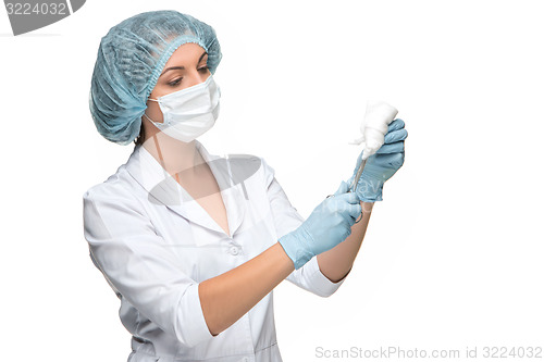 Image of Portrait of lady surgeon holding surgical instrument over white background