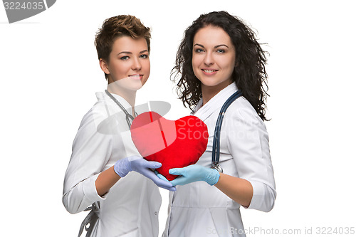 Image of Two woman doctor holding a red heart