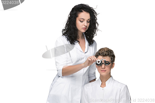 Image of Optometrist examines the sight of young girl