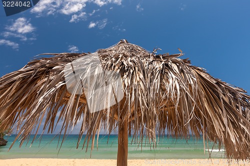 Image of straw umbrella on a tropical beach