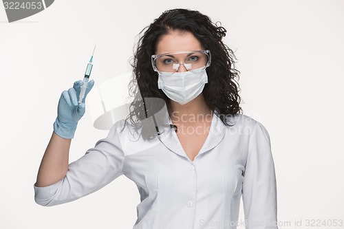 Image of Portrait of lady surgeon showing syringe over white background