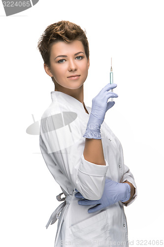 Image of Portrait of lady surgeon showing syringe 