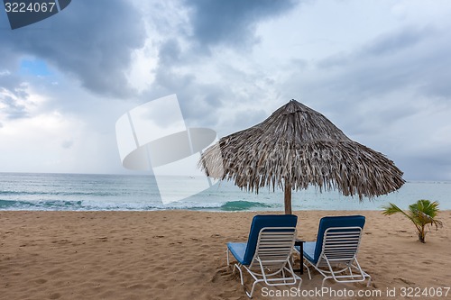 Image of Sunbed and umbrella on a tropical beach